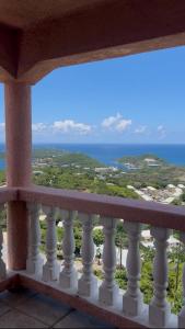 a balcony with a view of the ocean at Cozy House, Ocean View, Saint Thomas in Contant +13 photos