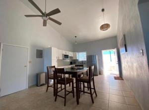 a kitchen and dining room with a table and chairs at Cozy House, Ocean View, Saint Thomas in Contant