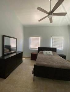 a bedroom with a bed and a ceiling fan at Cozy House, Ocean View, Saint Thomas in Contant