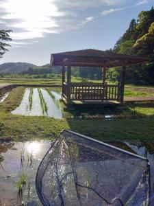 a view of a field with a gazebo at Nagata House in Ise