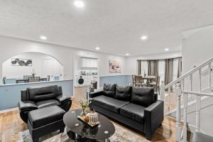 a living room with a couch and a table at Relaxation spot lawrenceville in Lawrenceville