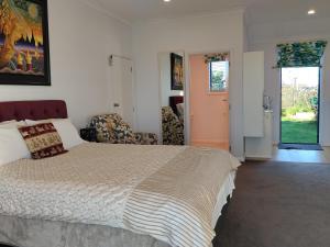 a bedroom with a large bed and a living room at Tree of Love in Cambridge