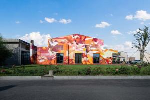 a building with a painting on the side of it at W9-Hotel ShangHai PuDong Airport - 24 hours free shuttle bus to Pudong Airport in Shanghai +66 photos