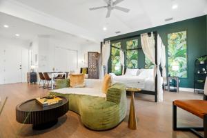 a bedroom with a bed and a living room at Casa Ybor Apartments on 7th Ave in Tampa