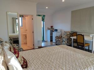 a bedroom with a bed and a table and chairs at Tree of Love in Cambridge