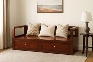 a wooden bench with pillows on it in a room at Best Eastern Suite in Dhaka +1 photo