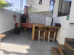 a room with two chairs and a bar on a boat at Recanto Guarujá Moc in Montes Claros