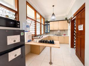 a large kitchen with a wooden counter top at OsteL By OstiC in Bandung