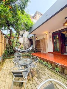 a patio with a table and chairs and a building at OsteL By OstiC in Bandung