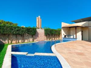 a swimming pool in the backyard of a house at Refúgio do poeta in Natal