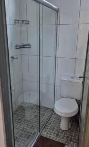 a bathroom with a toilet and a glass shower at Chalés Mirante da Lua Chalé 4 in Cavalcante +4 photos