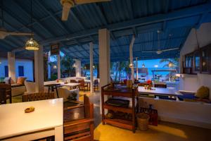 a restaurant with a view of the ocean at night at Surf Resort Arugambay in Arugam Bay +166 photos