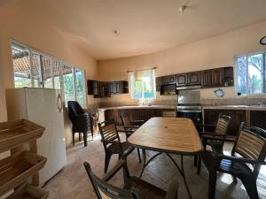 a kitchen with a table and chairs and a refrigerator at Casa Puerto in El Garitón