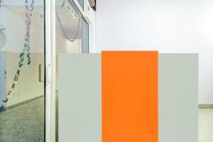 an orange and white door with a chain on it at Hotel O Ratan Pacific Hotel And Party Hall in Ghaziabad