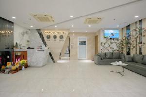a lobby of a store with a couch and a table at Moana Hotel Nha Trang in Nha Trang