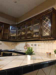 a kitchen with wooden cabinets and a counter top at Terra Vista Hotel in El Guayabo
