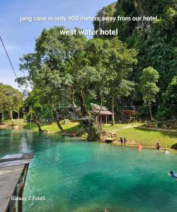 a view of a river with people swimming in it at west water hostel in Ban Khouaphan