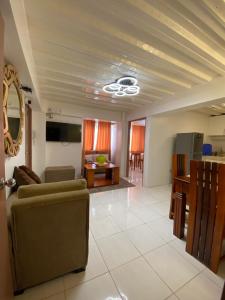 a living room with a couch and a table at The P Residences in San Agustin