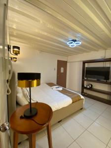 a bedroom with a bed and a lamp on a table at The P Residences in San Agustin