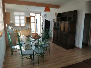 a dining room with a glass table and chairs at Villa Luna in Chincha
