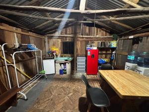 a garage with a red refrigerator and a table and chairs at Private Pool Villa Near Bacalar Lagoon in Xul-Ha