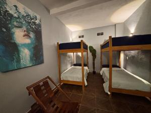 a room with two bunk beds and a painting on the wall at Private Pool Villa Near Bacalar Lagoon in Xul-Ha +93 photos