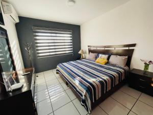 a bedroom with a bed and a window in it at Casa Fénix in Tepic