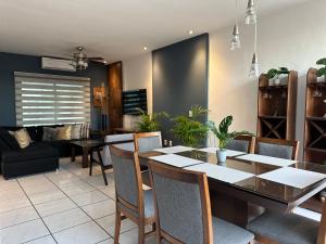 a dining room with a table and chairs at Casa Fénix in Tepic