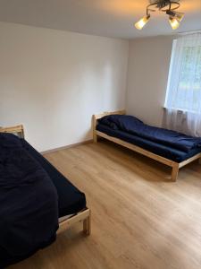 a bedroom with two beds in a room at Monteurhome Monteurzimmer A7 A5 in Niederaula