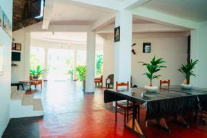 a living room with a table and chairs at Grace Inn in Kalkudah +18 photos