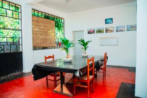 a dining room with a table and chairs at Grace Inn in Kalkudah