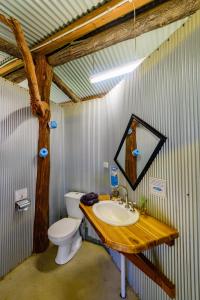 a bathroom with a sink and a toilet in it at Wallaroo Outback Retreat - Glamping Tents Carnarvon Gorge in Hutton