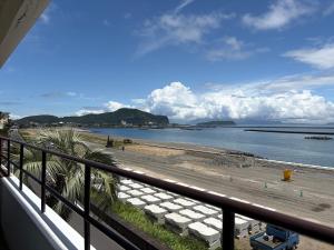 a view of a beach from a balcony at 指宿 潮音 Ibusuki Shione in Ibusuki