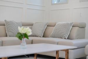 a white living room with a couch and a table at 초음정 Luxury Hanok Style Villa with Private Garden in Gyeongju in Gyeongju