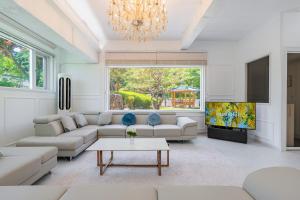 a living room with a couch and a tv at 초음정 Luxury Hanok Style Villa with Private Garden in Gyeongju in Gyeongju