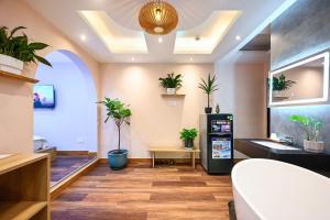 an office lobby with potted plants on the ceiling at Harmony Stay - Ben Thanh Market in Ho Chi Minh City
