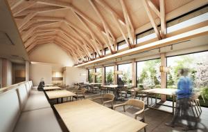 a cafeteria with tables and chairs and windows at らうす餐荘 in Rausu