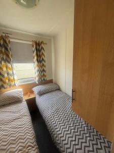 a small room with two beds and a window at Green Goddess in Skipsea +12 photos