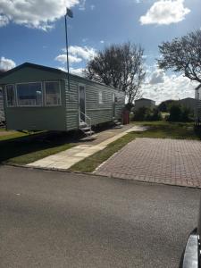 a mobile home on the side of a road at Green Goddess in Skipsea