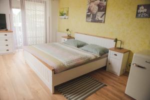 a bedroom with a large bed and a television at Penzion Pod Hradem in Potštejn +43 photos