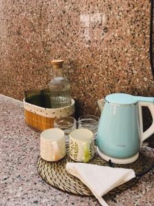 a table with a tea pot and cups on a counter at Parijat Heritage in Bhubaneshwar