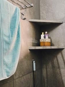 a towel and a toothbrush on a shelf in a bathroom at Parijat Heritage in Bhubaneshwar +81 photos