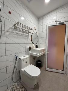a bathroom with a toilet and a sink at Grand Luxury Hotel Semporna in Semporna +45 photos