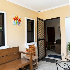 an open door into a living room with a bench at Block 23 - Dogwood in Bacolod