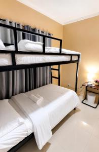 a bedroom with three bunk beds in a room at Block 23 - Dogwood in Bacolod