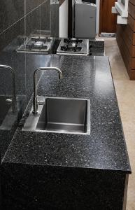 a black counter top with a sink in a kitchen at Block 23 - Dogwood in Bacolod +11 photos