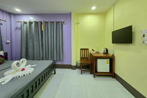 a bedroom with a bed with a flower on it at Smilingface guesthouse in Sukhothai