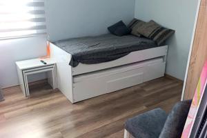 a small bedroom with a bed and a table at Caesar resort 2 bedrooms Cornelius in Vrysoules