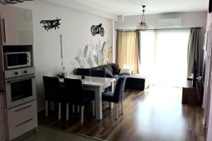 a kitchen and living room with a table and chairs at Caesar resort 2 bedrooms Cornelius in Vrysoules