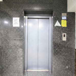 a silver elevator door in a building at Sri Ganapathy Lodge in Coimbatore